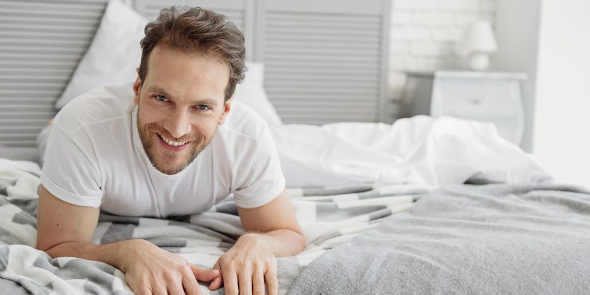 Carefree guy resting in bedroom